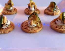 Gruyere biscuits topped with chargrilled courgette, marinated goats cheese and pinenuts